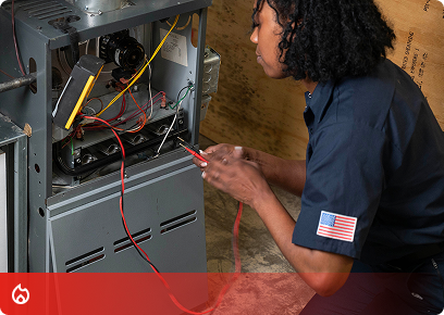 Heating service call-to-action tile: a technician testing the wiring inside an open furnace with multimeter leads