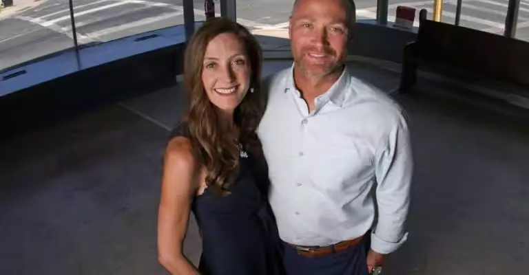 A woman and a man standing together in a bright open interior